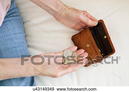 Close up of older woman counting coins View Large Photo Image Stock Photo - Close up of older woman counting coins. Fotosearch