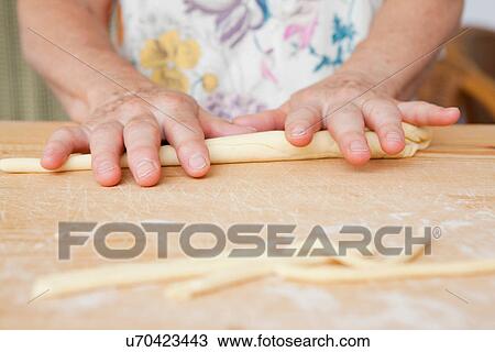 Close up of older woman rolling dough View Large Photo Image Stock Image - Close up of older woman rolling dough. Fotosearch