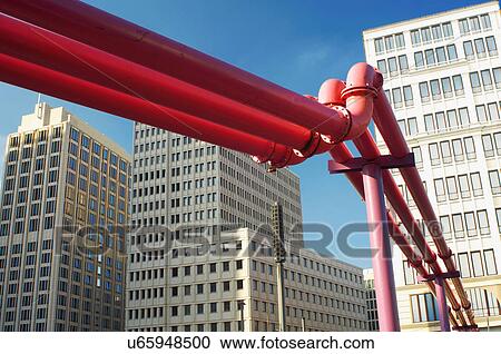 Stock Image - Close up of red pipes in city center. Fotosearch
