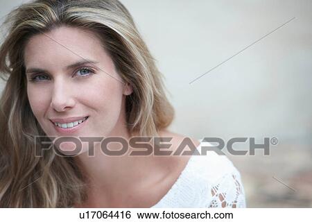 Stock Photograph - Close up of smiling woman's face. Fotosearch