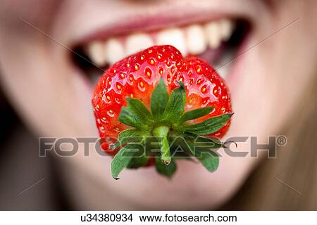 Close up of strawberry in woman's mouth View Large Photo Image Picture - Close up of strawberry in woman's mouth. Fotosearch