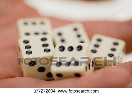 Picture - Close up of woman holding dice. Fotosearch