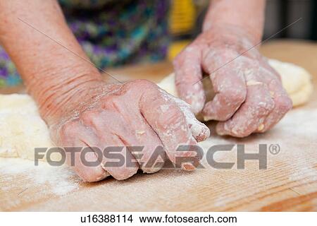 Picture - Close up of woman kneading dough. Fotosearch