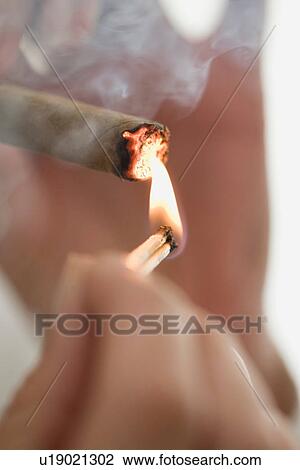 Close up of woman lighting cigarette View Large Photo Image Stock Image - Close up of woman lighting cigarette. Fotosearch