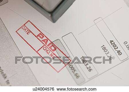 Stock Photograph - Close up of woman stamping paid. Fotosearch