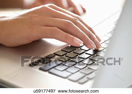 Close up of woman typing on laptop View Large Photo Image Stock Photo - Close up of woman typing on laptop. Fotosearch