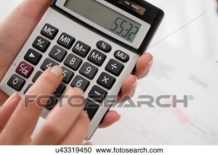 Close up of woman using calculator View Large Photo Image Stock Image - Close up of woman using calculator. Fotosearch