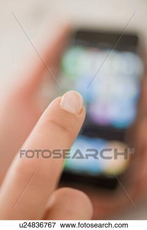 Stock Photo - Close up of woman using cell phone. Fotosearch