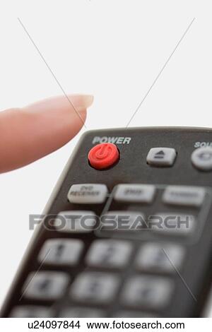 Picture - Close up of woman using remote control. Fotosearch