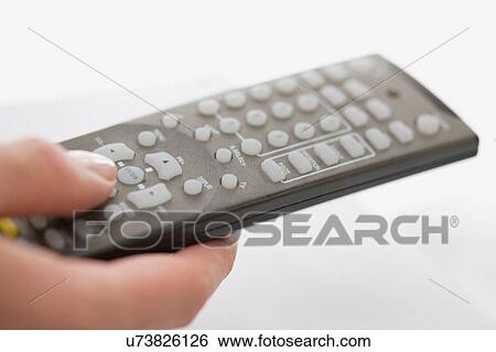 Close up of woman using remote control View Large Photo Image Stock Photograph - Close up of woman using remote control. Fotosearch