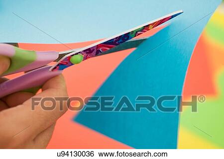 Stock Photograph - Close up of woman using scissors. Fotosearch