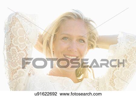 Stock Image - Close up of womans smiling face. Fotosearch