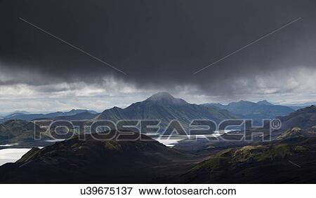 Clouds looming over rural landscape View Large Photo Image Stock Photo - Clouds looming over rural landscape. Fotosearch