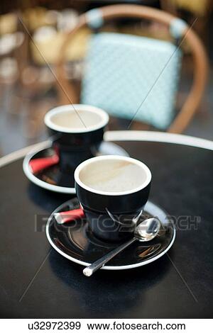 Coffee cups at table in cafe View Large Photo Image Stock Photo - Coffee cups at table in cafe. Fotosearch