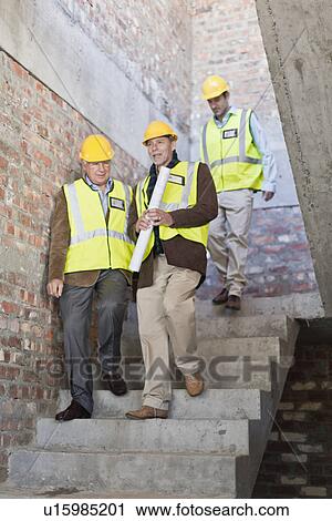 Construction workers walking on steps View Large Photo Image Stock Image - Construction workers walking on steps. Fotosearch