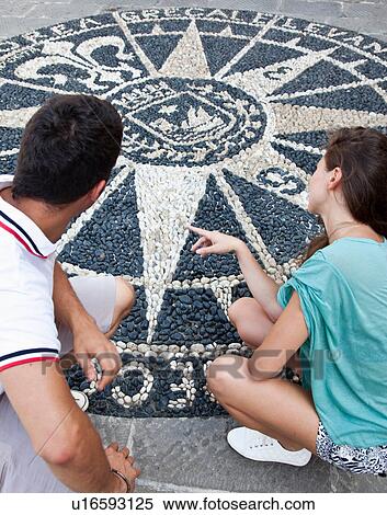 Stock Photography - Couple admiring ornate cobblestones. Fotosearch