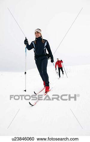 Couple cross-country skiing in snow View Large Photo Image Stock Image - Couple cross-country skiing in snow. Fotosearch