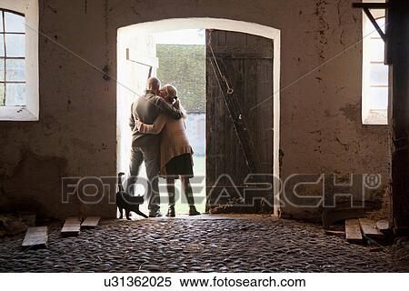 Couple hugging at barn doors View Large Photo Image Stock Photography - Couple hugging at barn doors. Fotosearch