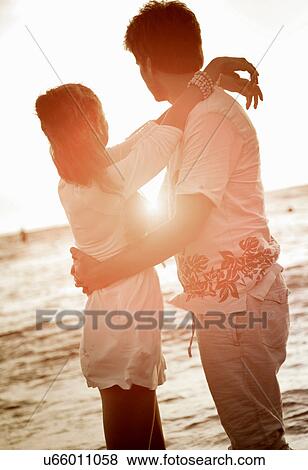 Stock Photo - Couple hugging at beach. Fotosearch