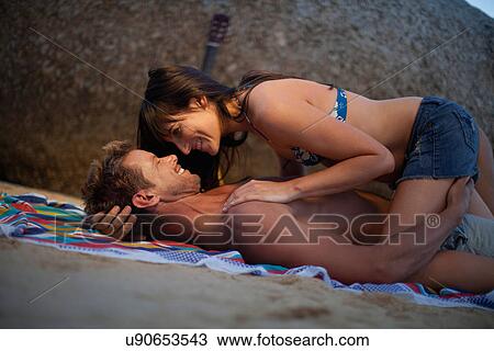 Couple hugging on beach towel View Large Photo Image Stock Image - Couple hugging on beach towel. Fotosearch