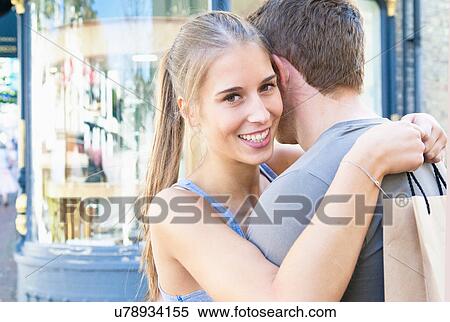 Stock Photography - Couple hugging on city street. Fotosearch