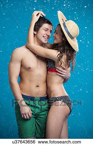 Couple in swimsuits hugging in snow View Large Photo Image Stock Photograph - Couple in swimsuits hugging in snow. Fotosearch