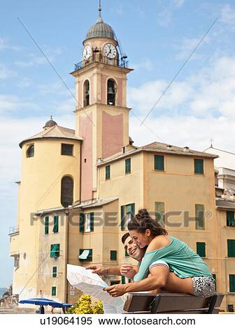 Stock Photography - Couple on vacation reading map. Fotosearch