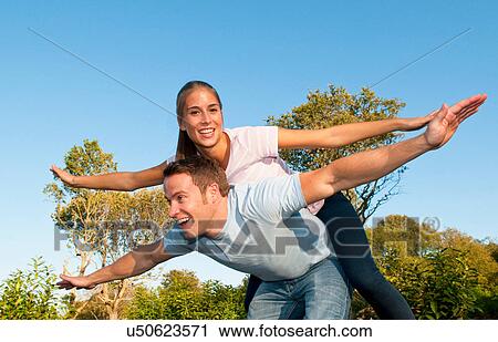 Couple playing together in park View Large Photo Image Stock Image - Couple playing together in park. Fotosearch