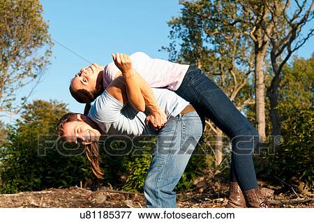 Couple playing together in park View Large Photo Image Stock Photo - Couple playing together in park. Fotosearch