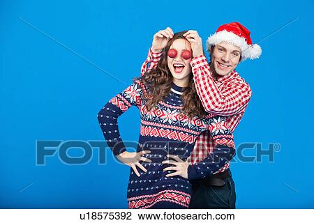 Couple playing with Christmas ornaments View Large Photo Image Stock Image - Couple playing with Christmas ornaments. Fotosearch