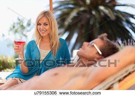 Stock Photograph - Couple relaxing in lawn chairs. Fotosearch