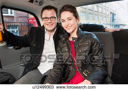 Couple smiling in back seat of car View Large Photo Image Stock Image - Couple smiling in back seat of car. Fotosearch