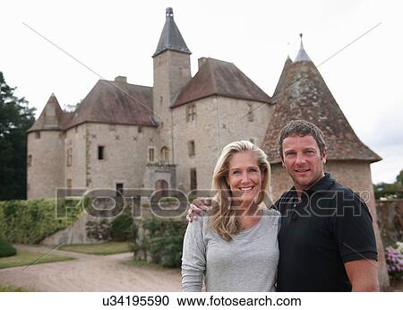 Couple smiling outside medieval castle View Large Photo Image Stock Image - Couple smiling outside medieval castle. Fotosearch