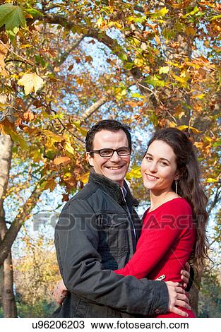 Couple smiling under fall leaves View Large Photo Image Stock Image - Couple smiling under fall leaves. Fotosearch