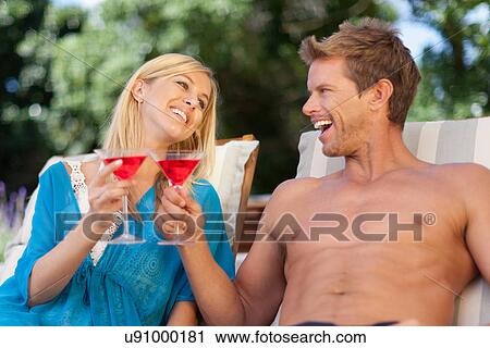 Couple toasting each other outdoors View Large Photo Image Stock Image - Couple toasting each other outdoors. Fotosearch