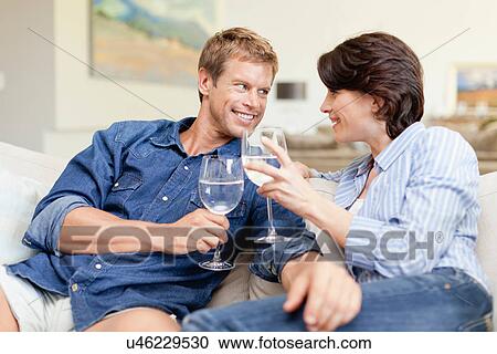 Couple toasting each other with wine View Large Photo Image Stock Image - Couple toasting each other with wine. Fotosearch