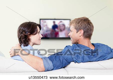 Couple watching television together View Large Photo Image Stock Image - Couple watching television together. Fotosearch