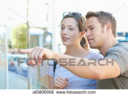 Stock Photo - Couple window shopping together. Fotosearch