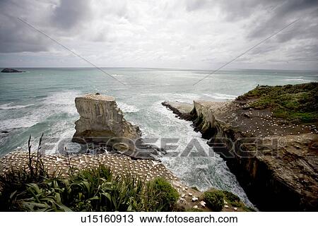 Stock Image - Craggy rocks jutting into ocean. Fotosearch