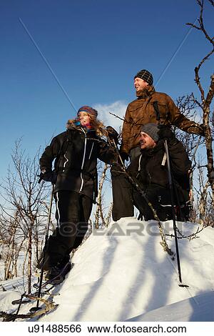 Cross-country skiers resting in snow View Large Photo Image Stock Photograph - Cross-country skiers resting in snow. Fotosearch