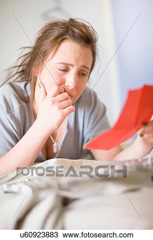 Stock Image - Crying teenage girl reading letter. Fotosearch