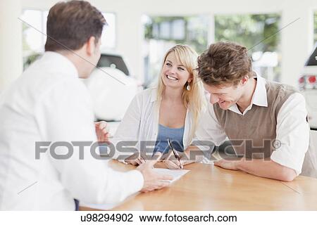 Customers signing at car dealership View Large Photo Image Stock Image - Customers signing at car dealership. Fotosearch