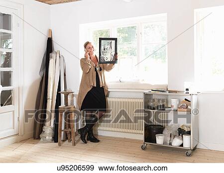 Stock Photo - Designer admiring panel on telephone. Fotosearch