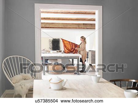Picture - Designer working with textiles in studio. Fotosearch