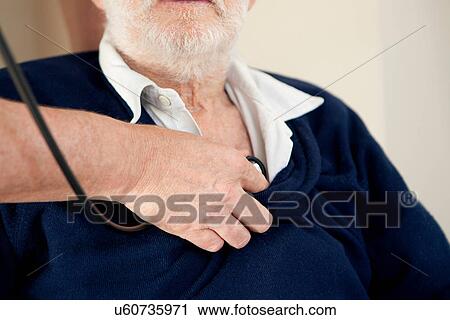 Doctor listening to older man's heart View Large Photo Image Stock Image - Doctor listening to older man's heart. Fotosearch