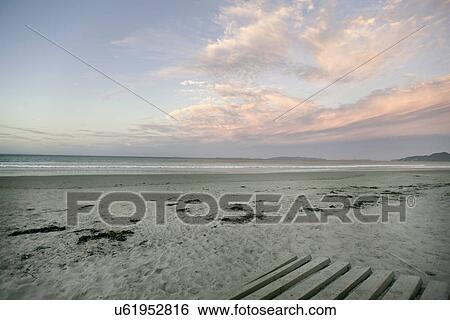Empty beach under cloudy sky View Large Photo Image Stock Photograph - Empty beach under cloudy sky. Fotosearch