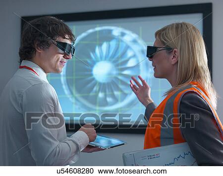 Engineer and apprentice in 3D glasses discussing engine on 3D screen View Large Photo Image Stock Image - Engineer and apprentice in 3D glasses discussing engine on 3D screen. Fotosearch