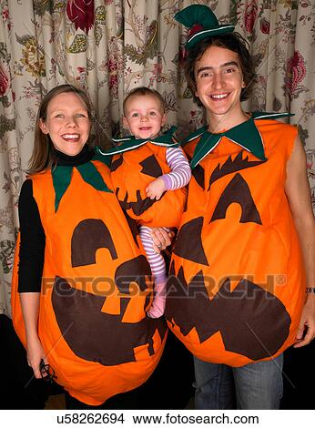 Family dressed as pumpkins for Halloween View Large Photo Image Picture - Family dressed as pumpkins for Halloween. Fotosearch