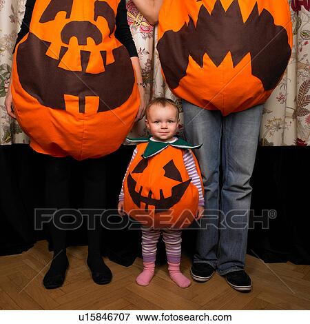 Family dressed as pumpkins for Halloween View Large Photo Image Stock Photo - Family dressed as pumpkins for Halloween. Fotosearch