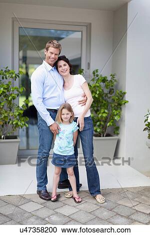 Family smiling outside front door View Large Photo Image Stock Image - Family smiling outside front door. Fotosearch